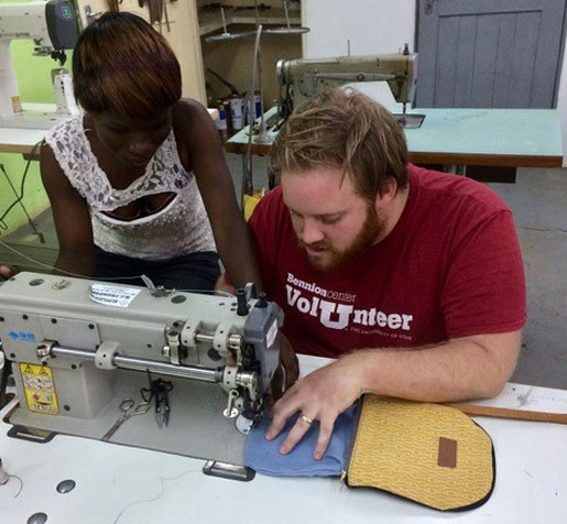Second-year student Jeremy Lofthouse, right, learns to sew a handbag