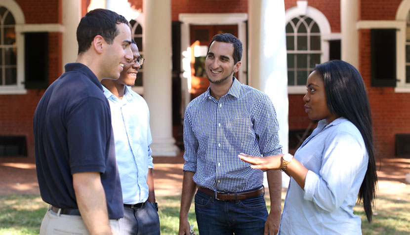 UVA Law students and Tri-Sector fellows Alex Hoffarth ’18, Gannam Rifkah ’17 and Charis Redmond ’17 talk with Darden student and fellow Dana Adams, second from left.