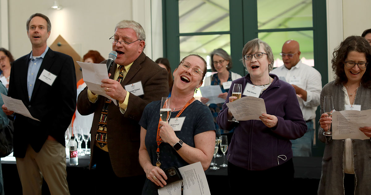 Faculty sing at the midway toast