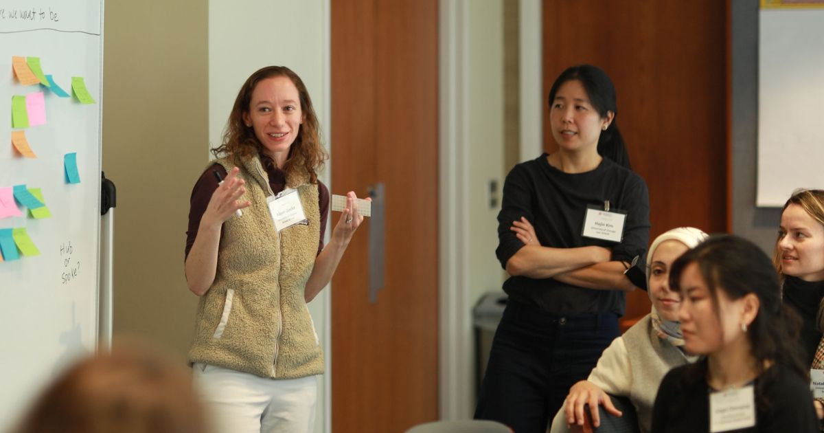Professor Alison Gocke talks with conference attendees