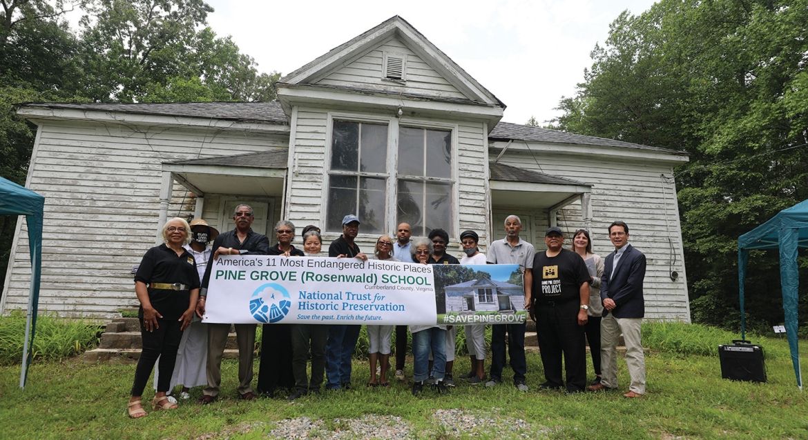 Community members stand in front of Pine Grove School