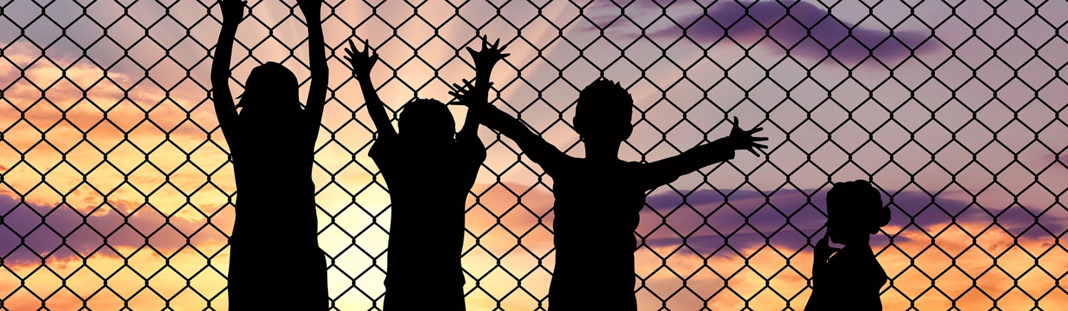 Image of children at a border fence