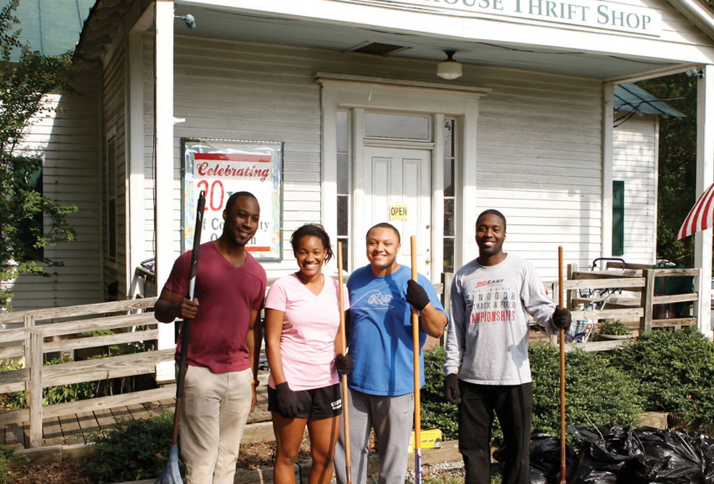 Black Law Students Association members and 2014 classmates Andrew Person, Andrea Canfield, Andrew Thebaud, and Sean Suber clean up outside the Schoolhouse Thrift Shop in Charlottesville as part of the organization’s community service week in 2012. 