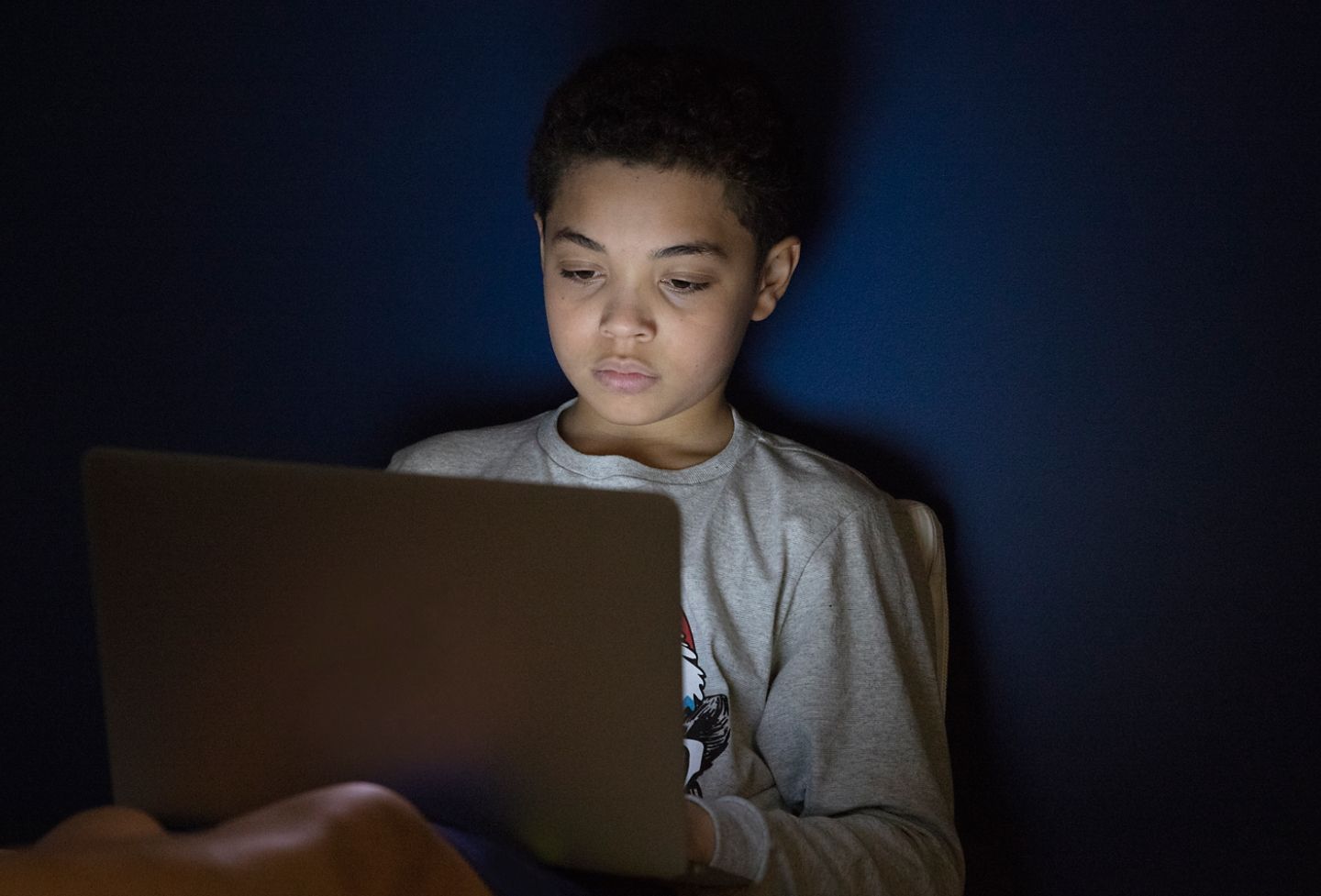 Boy looking at laptop