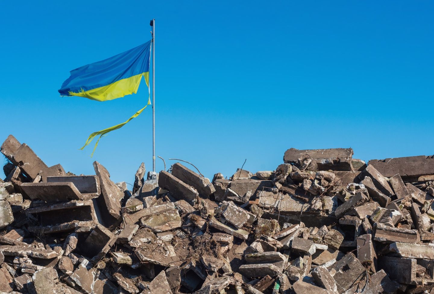 Ukrainian flag over rubble