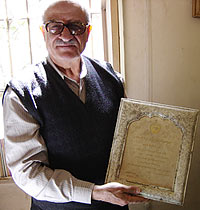 Damascus lawyer Haitham al-Maleh holds up an award from the Egyptian Human Rights Association