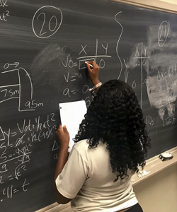 Student at a blackboard